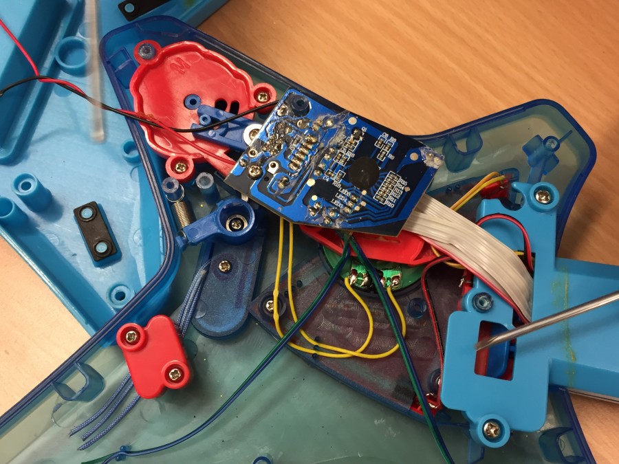 Photo of inside of an electronic toy guitar